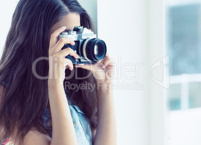 Stylish young woman taking a photo