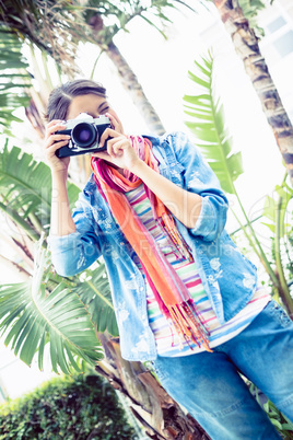 Pretty brunette taking a photo outside