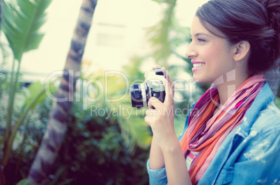 Smiling brunette taking a photo