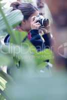 Young woman taking a picture in a wooded area