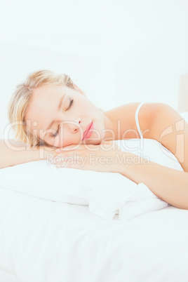 Attractive young blonde sleeping on her bed