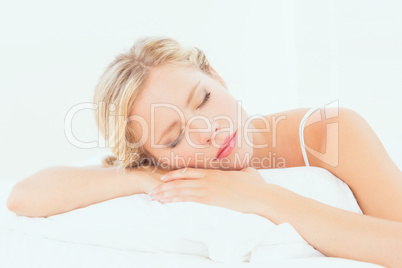 Peaceful young blonde sleeping on her bed