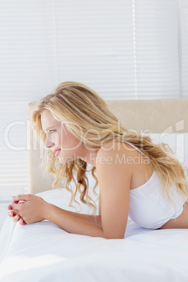 Attractive young blonde woman on her bed