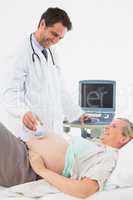 Smiling pregnant woman having an ultrasound scan