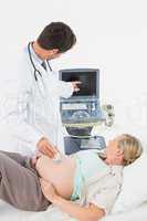 Blonde pregnant woman having an ultrasound scan