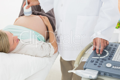 Blonde pregnant woman having a sonagram scan