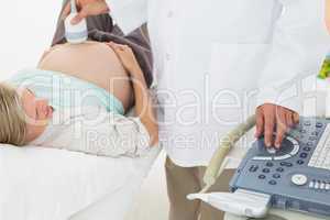 Blonde pregnant woman having a sonagram scan