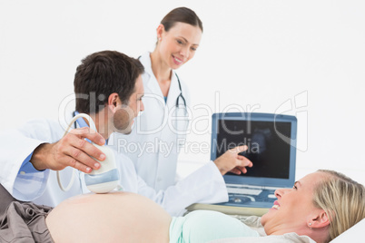 Smiling pregnant blonde having an ultrasound scan