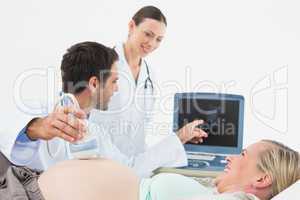 Smiling pregnant blonde having an ultrasound scan