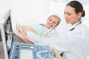 Happy pregnant blonde having an ultrasound scan