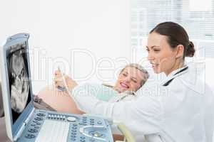 Cheerful pregnant blonde having an ultrasound scan