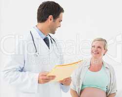 Happy pregnant woman having a check up with doctor