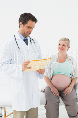 Cheerful pregnant woman having a check up with doctor