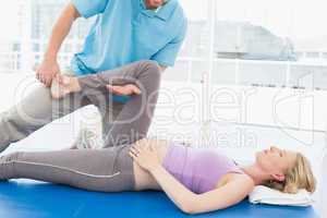Blonde pregnant woman getting a calming massage