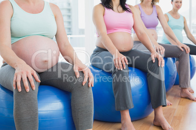 Pregnant women sitting on exercise balls