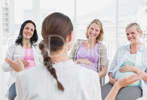 Pregnant women listening to doctor at antenatal class