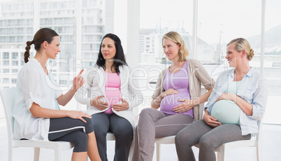 Pregnant women talking together at antenatal class