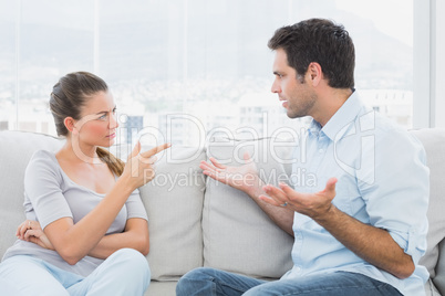 Couple having a serious argument on the couch Couple having a serious argument on the couch