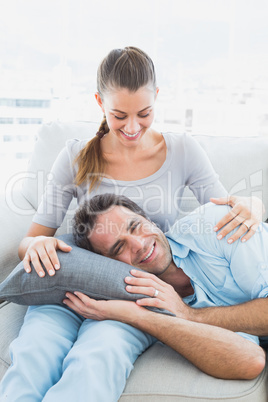 Smiling couple relaxing on the couch together