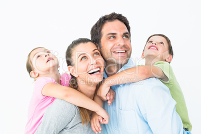 Happy young family looking up together