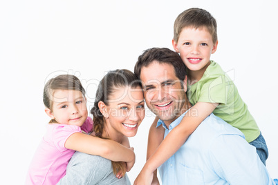 Cheerful young family looking at camera together Cheerful young family looking at camera together