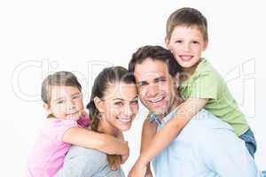 Cheerful young family looking at camera together