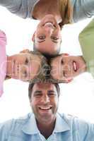 Cute family smiling down at camera together