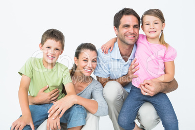 Cute family posing and smiling at camera together