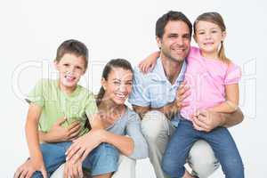 Cute family posing and smiling at camera together