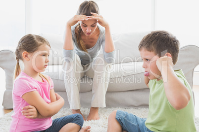 Fed up mother listening to her young children fight