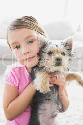 Little girl holding her yorkshire terrier puppy