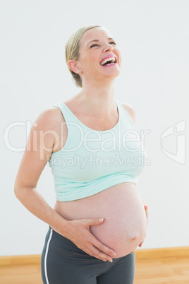 Blonde pregnant woman laughing