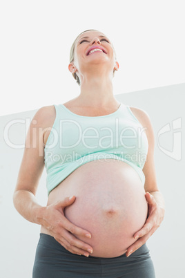 Blonde pregnant woman looking up