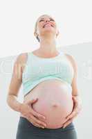 Blonde pregnant woman looking up