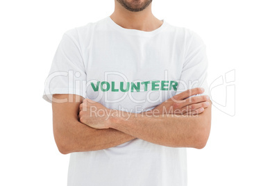 Mid section of a male volunteer with hands folded