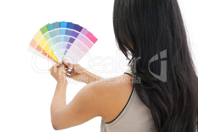 Rear view of a woman looking at paint samples