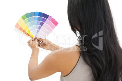 Rear view of a woman looking at paint samples