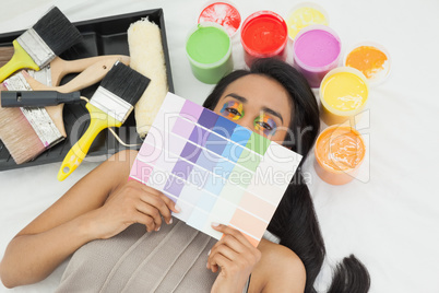 Woman with paint samples and paintbrush