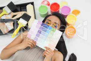 Woman with paint samples and paintbrush