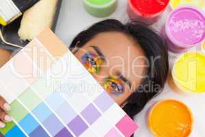 Portrait of a young woman with paint samples