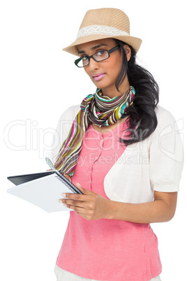 Cool young woman writing in notepad