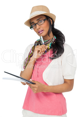 Portrait of a cool young woman writing in notepad