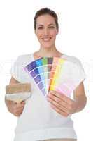 Portrait of a woman with paint samples and paintbrush