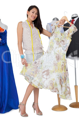 Portrait of a female fashion designer and mannequins