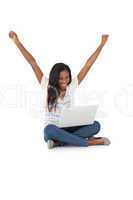 Cheerful young woman with laptop raising hands
