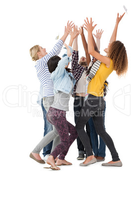 Casually dressed happy young people raising hands