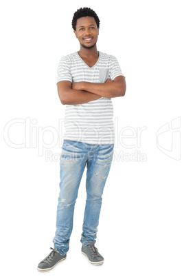 Full length portrait of a smiling man with arms crossed