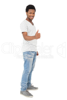Portrait of a happy young man gesturing thumbs up