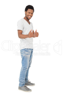 Portrait of a happy young man gesturing thumbs up