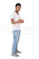 Portrait of a happy young man gesturing thumbs up